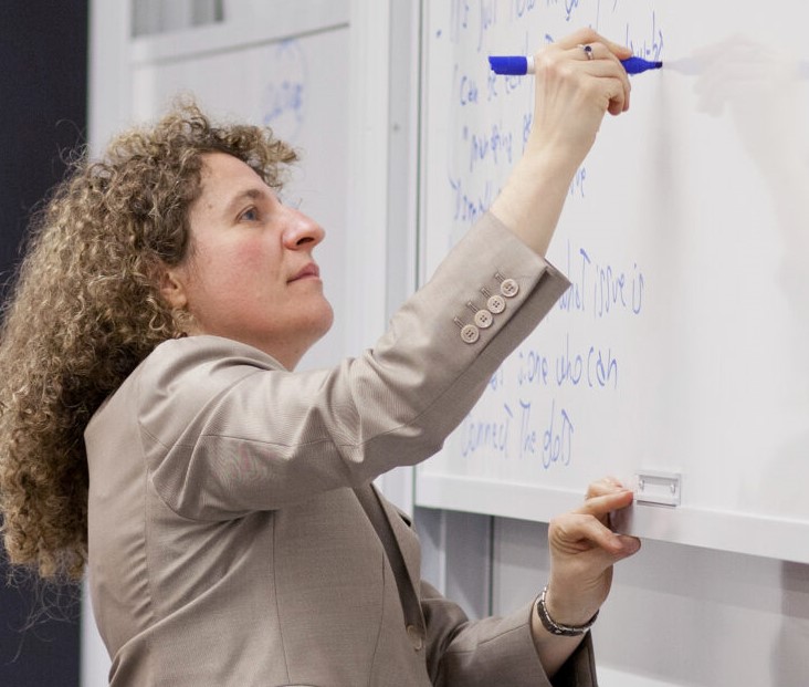 Photo of Professor Tiziana Casciaro writing on a white board